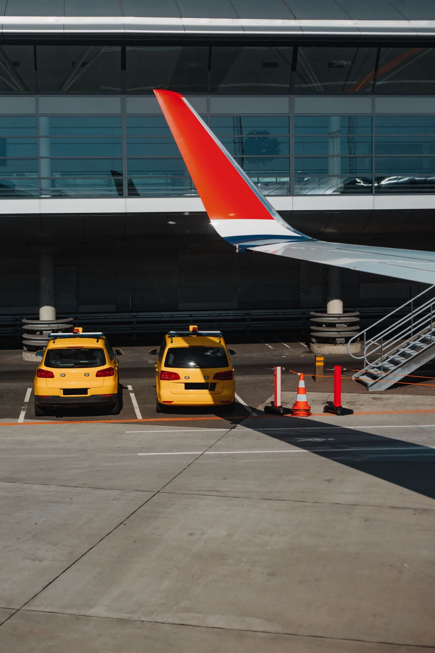 Airport transfer vehicles waiting outside a terminal
