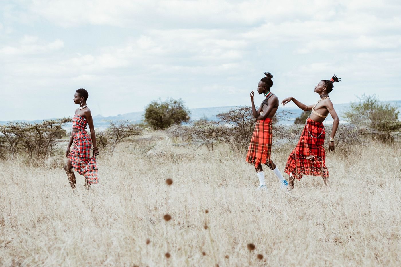 People walking across an African grassland